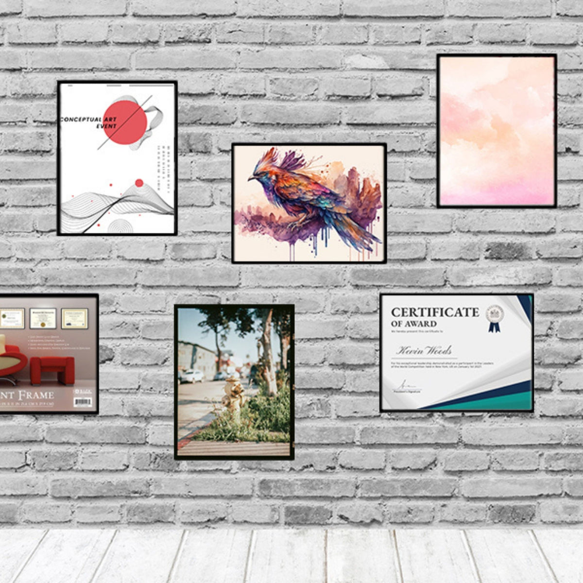 Black frames display art, a photo and a certificate in portrait and landscape orientations on a white brick wall.