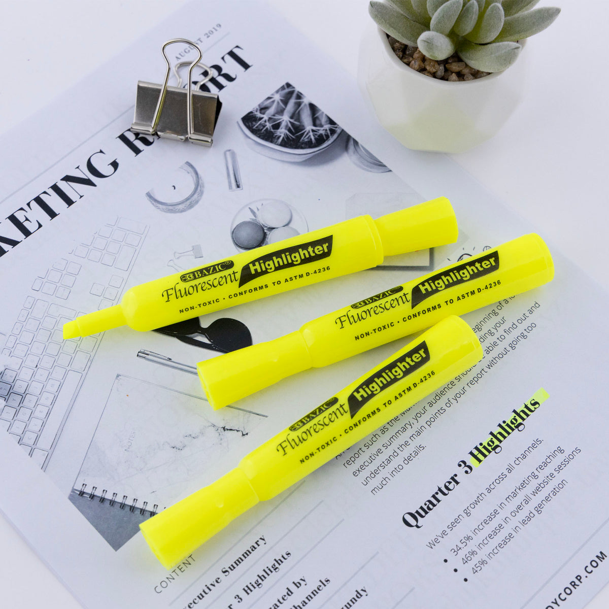 Three yellow highlighters rest on a report with yellow-highlighted text; one has its chisel tip exposed.
