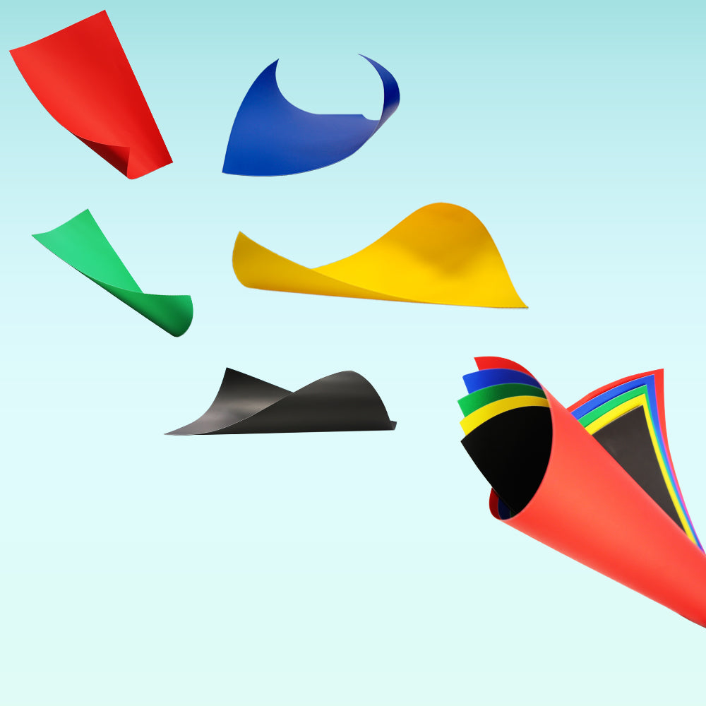 Red, blue, green, yellow and black poster boards shown curled individually and together in a stack.