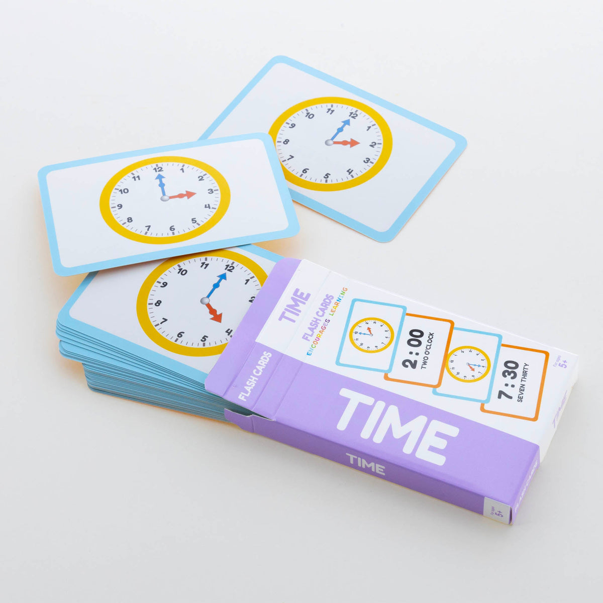 Open purple Time flash card box with blue-bordered clock cards; package shows 2:00, 7:30 and ages 3+.