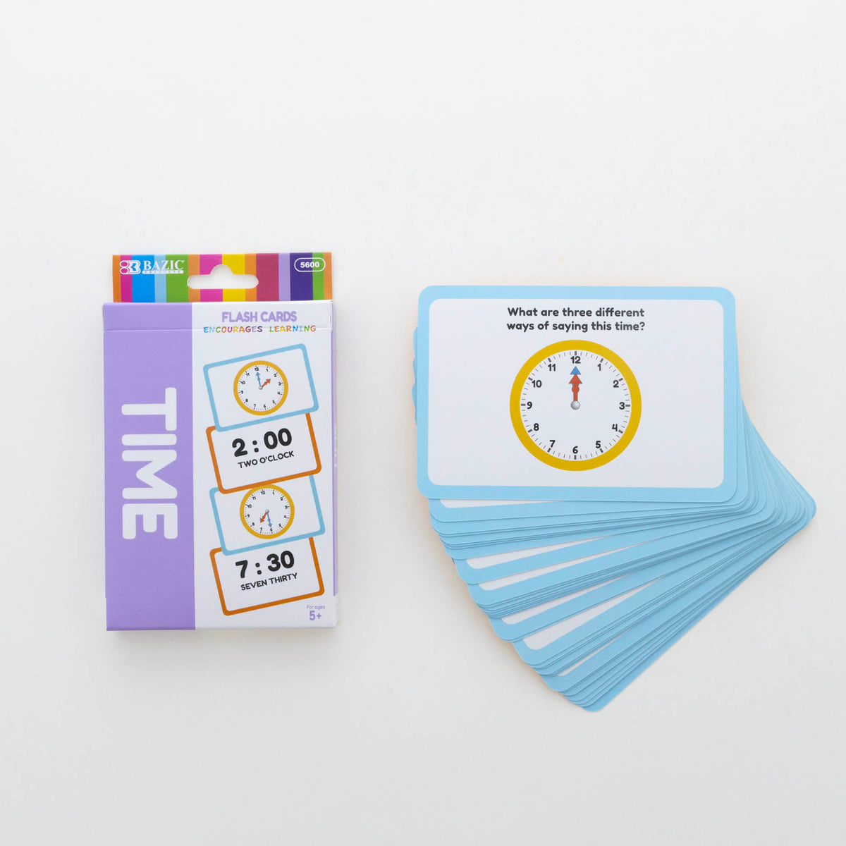 Blue-bordered cards beside an ages 5+ box; top card shows 12:00 and asks for three different ways of saying this time.