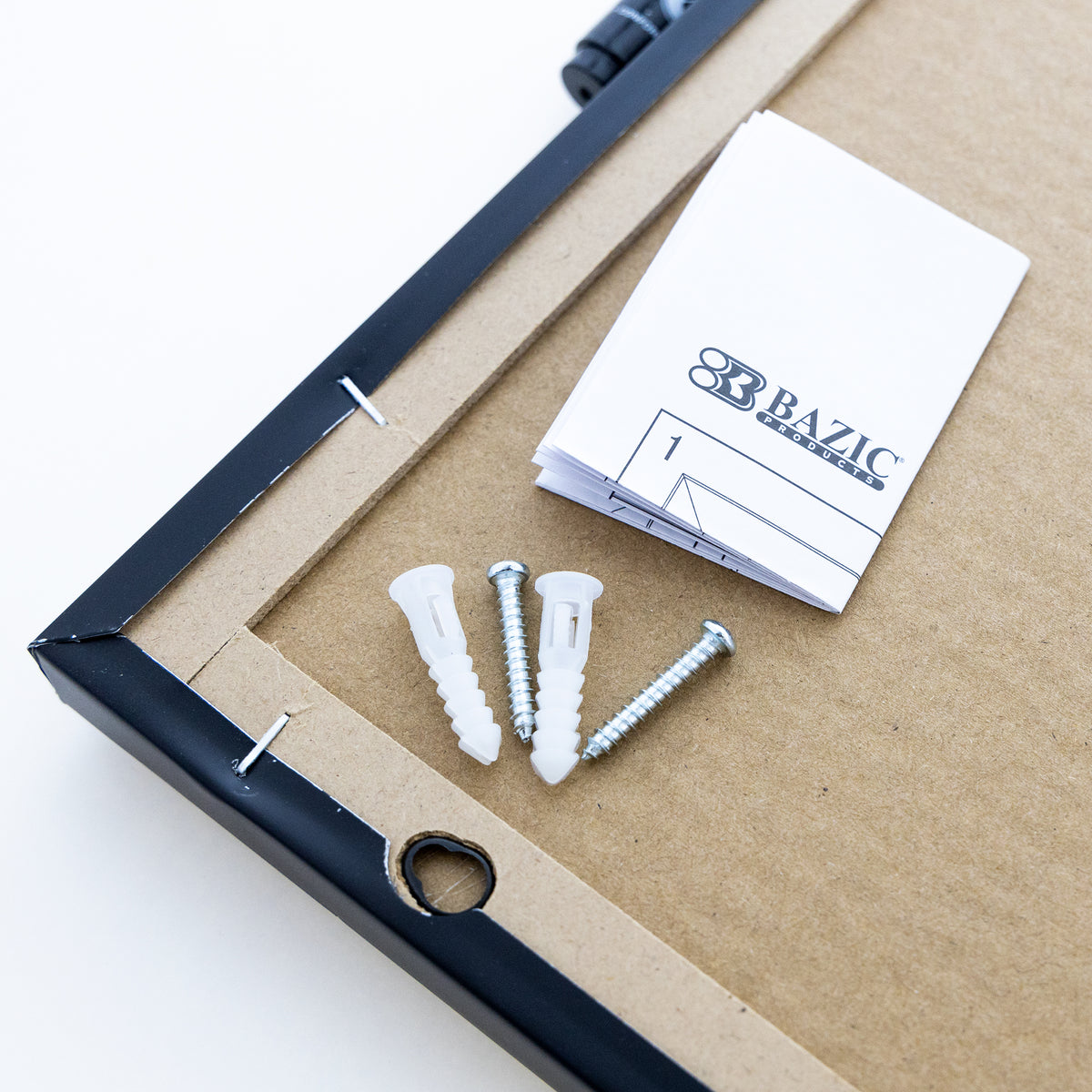 Back of chalkboard with a hanging hole, two screws, two white wall anchors and a folded instruction leaflet.